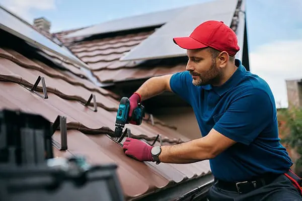 Contractor installing new roof shingles